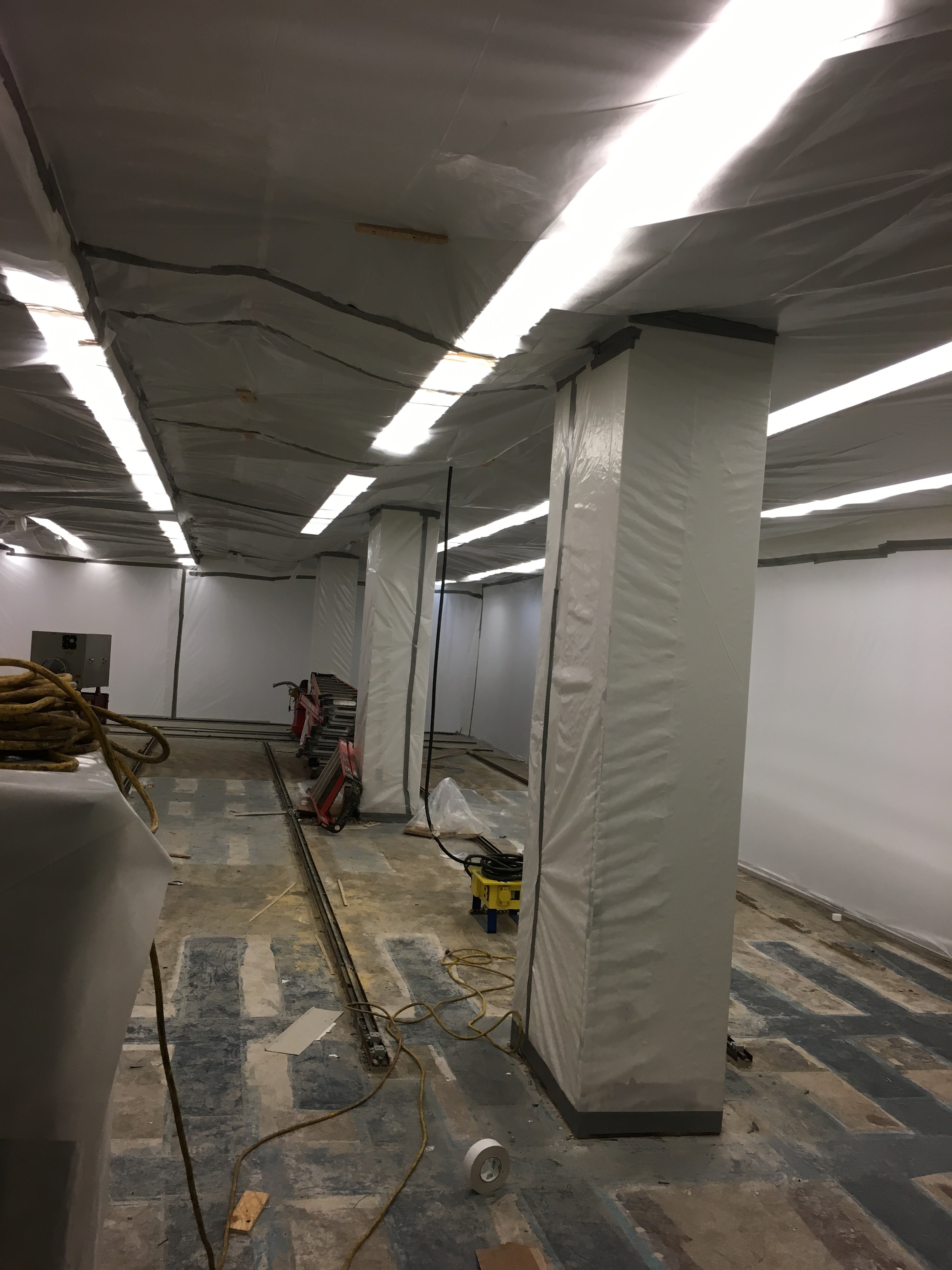 A view inside a containment for a decommissioning project showing plastic sheeting covering surfaces that will be preserved.