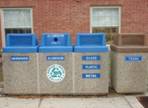 A set of outside recycle bins.